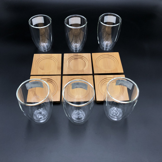 A Set Of 6 Bamboo Coaters/ Trays With 6 Doublewalled Thermo Glasses To Match